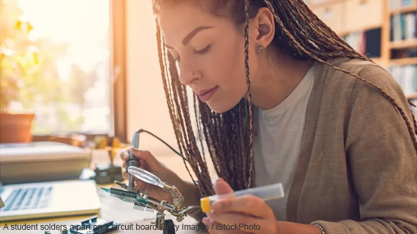 A student solders a part on a circuit board.Getty Images / iStockPhoto